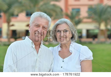 Portrait of a happy elderly couple embracing outdoors in nature.