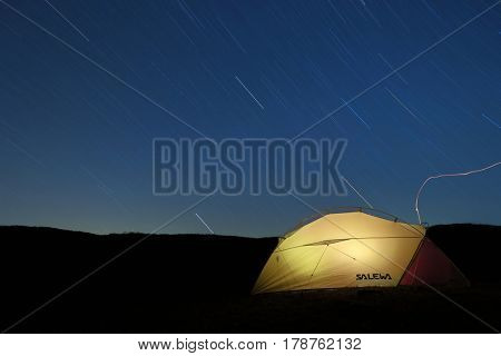 NEBRODI PARK, SICILY - MARCH 24, 2017: star trails on lighting semi-geodesic tent Salewa in Nebrodi Park 