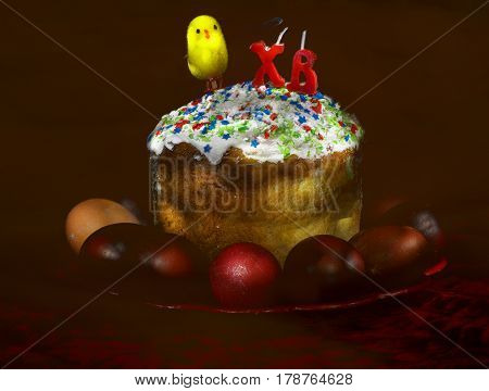 Easter cake and eggs on dark background morning after easter. Paintd with lightbrush