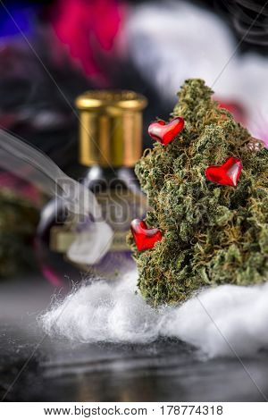 Macro detail of cannabis bud (love potion marijuana strain) with smoke dark background