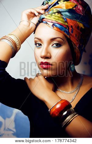 beauty bright real african woman with creative make up, shawl on head like cubian closeup smiling