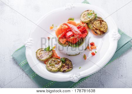 Rice timbale with fried zucchini peppers, carrots