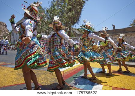 ARICA, CHILE - FEBRUARY 11, 2017: Tinkus Dance Group dressed in ornate costumes performing a Tinkus dance during a street parade at the annual Carnaval Andino con la Fuerza del Sol.