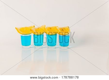 Four Glasses Of Blue Kamikaze, Glamorous Drink, Mixed Drink Poured Into Shot Glasses