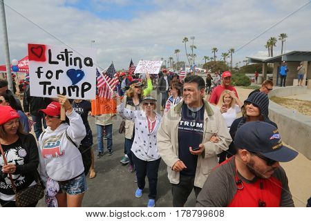 Huntington Beach, CA - March 25 2017: Make America Great Again March. Thousands of Supporters of republican president Donald Trump, wave flags, signs and march at a MAGA March in Huntington Beach. 

