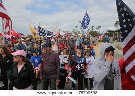 Huntington Beach, CA - March 25 2017: Make America Great Again March. Thousands of Supporters of republican president Donald Trump, wave flags, signs and march at a MAGA March in Huntington Beach. 
