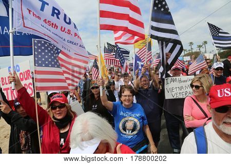 Huntington Beach, CA - March 25 2017: Make America Great Again March. Thousand of Supporters of republican president Donald Trump, march and wave flags, at a MAGA March in Huntington Beach. 



