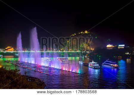 Liuzhou, China - September 28, 2016: Music Fountain On The Liujiang River With Boats And Karst Forma