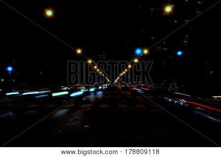 Cars blurred in motion at night street scene