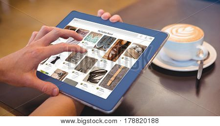 Composite image of website page against close-up of digital tablet and coffee on table Close-up of digital tablet and coffee on table in the coffee shop