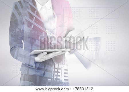Midsection of businesswoman using digital tablet against buildings in city 3d
