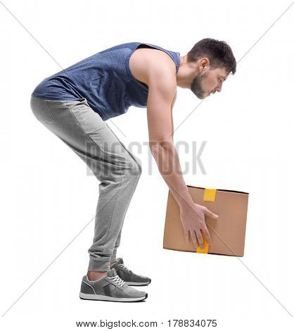 Posture concept. Man lifting heavy cardboard box against white background