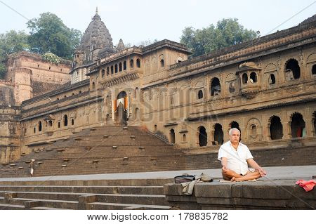 Man Doing Yoga And Meditation In Front Of Maheshwar Palace
