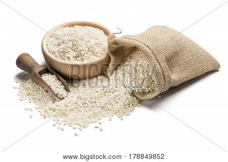 white rice in wooden bowl and juta bag on white background