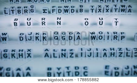 Burn out letters highlighted out between other blurred lettters.