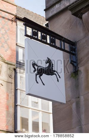 Chester England UK - March 25 2017: Lloyds sign with its familiar prancing black horse logo outside a high street branch. Lloyds is largest retail bank in the United Kingdom with over 16 million customers and was founded in 1765