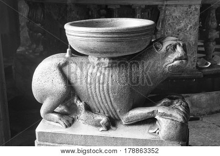 COMO, ITALY - JUNE 27, 2016: Como (Lombardy Italy): interior of the medieval cathedral built from 1396 to 1770: Holy water font. Black and white