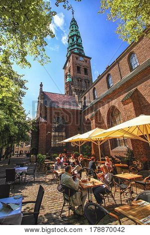 COPENHAGEN DENMARK - JUNE 15: Summer cafe in the courtyard at the walls of St. Nicholas Church in 2012