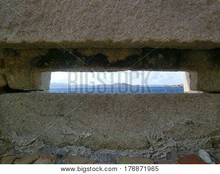 Granite window in old fortification with sea panorama Caprera Island Sardinia Italy