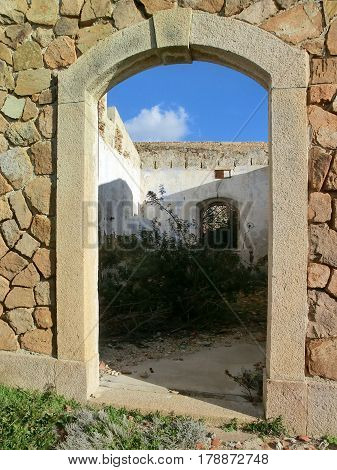 Granite door in old stone fortification Caprera Island Sardinia Italy