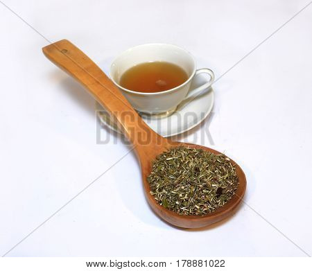cup of tea and herbs on a wooden Net Worth on a white background