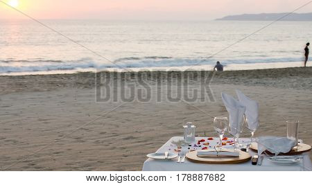 Couple sunset dinner on beach with problems