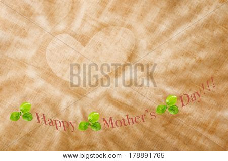 Happy mother's day card with green leaves parrots on sackcloth and in the center drawing a heart