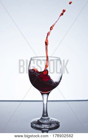 moving red wine glass over a white background on a white background freezing
