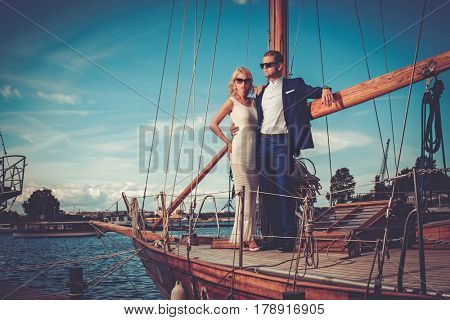 Stylish wealthy couple on a luxury yacht