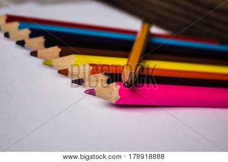 color pencils and pencil folded in a row