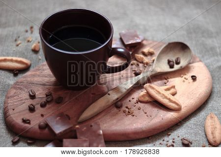 warm cup of ciffee on brown background. chocolate. biscuit