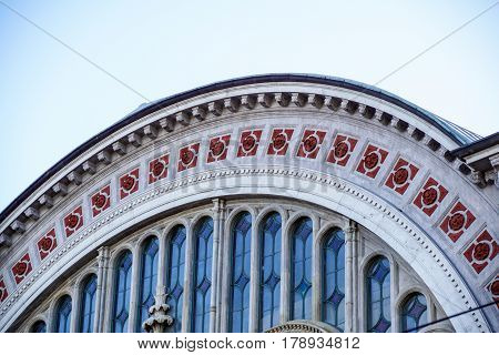Detail of the facade of semi-circular wall with empty arched windows without glass. Ancient building .