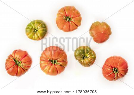 An overhead photo of Spanish Raf tomatoes on a white background with a place for text