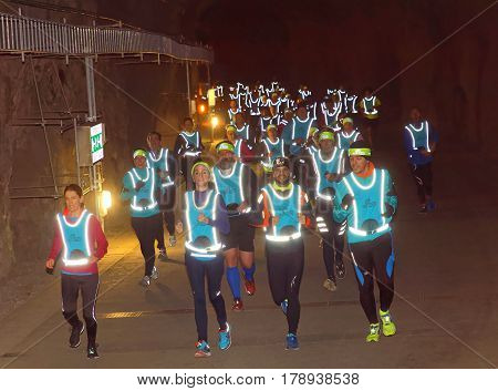 STOCKHOLM SWEDEN - MAR 25 2017: Group of runners in reflex vest in a dark tunnel in the Stockholm Tunnel Run Citybanan 2017. March 25 2017 in Stockholm Sweden