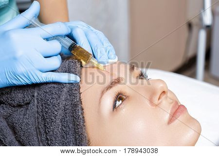 procedure Plasmolifting injection. plasma injection into the skin of the forehead of the patient