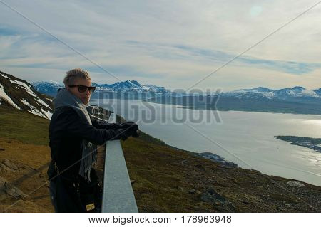 A beautiful girl looking at mountains inside artic circle