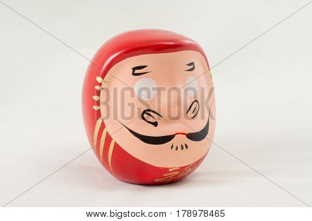 Japanese figurine head samurai on a white background on the table subject shooting red one closeup