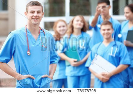 Young student with groupmates outdoors
