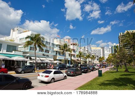 MIAMI BEACH FLORIDA - FEBRUARY 15 2017: Tourists stroll along famous Ocean Drive which runs parallel to Southbeach in Miami Beach Florida USA on February 15 2017.