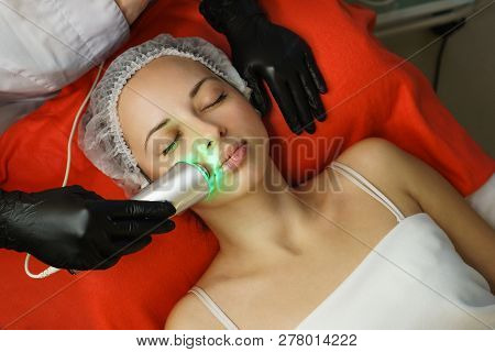 Hardware Cosmetology. Beautician Makes Ultrasonic Skin Tightening Client. Skin Pore Cleansing. Anti-