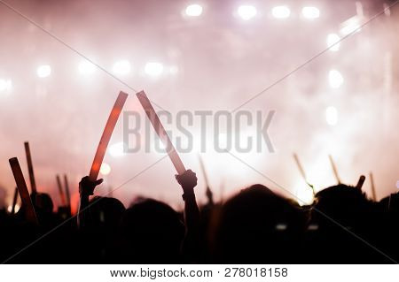 Silhouettes Of Hand In Concert.light From The Stage.