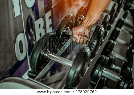 Rows Of Dumbbells In The Gym With Hign Contrast And Monochrome Color Tone.