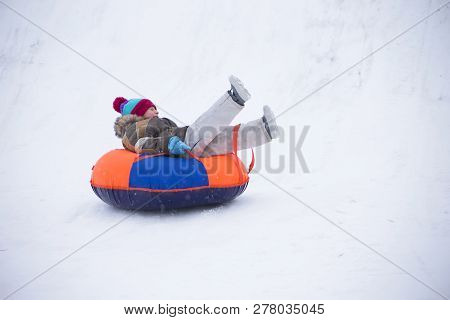 Sledding.happy Child On Vacation. Winter Fun And Games.little Boy Enjoying A Sleigh Ride.children Pl