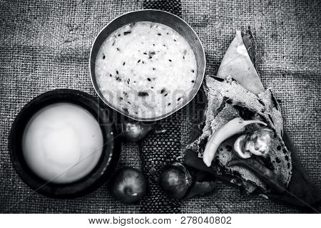Close Up Of Poor Man's Complete Milk On Gunny Bag's Background With White Lentil,pearl Millet Roti O