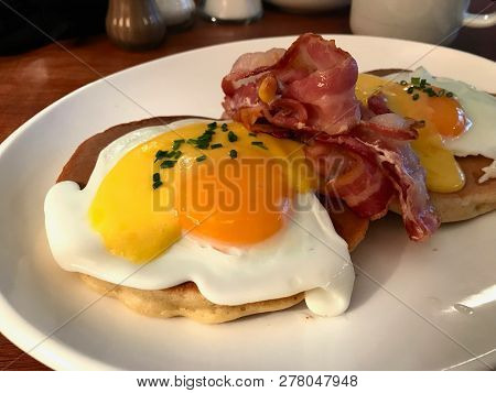 Salted Pancakes With Hollandaise Suace, Eggs And Crispy Bacon For Breakfast. Salty Fast Food.