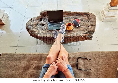 Man With Coffee / Tea And Laptop On A Home Porch.