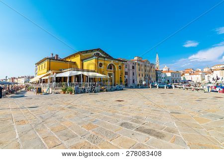 Piran, Slovenia - 24.7.2018: View Of Piran Harbor With Boats. Tourists Are Walking Near The City Coa