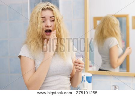 Young Blonde Female Feeling Dull And Tired After Waking Up. Woman Yawning Being Sleepy In Bathroom.