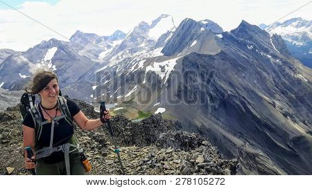 A Female Hiker Backcountry Hiking Through The Remote, Secluded, And Beautiful Rocky Mountains In Kan