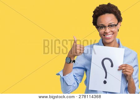 Young african american woman holding paper with question mark over isolated background happy with big smile doing ok sign, thumb up with fingers, excellent sign